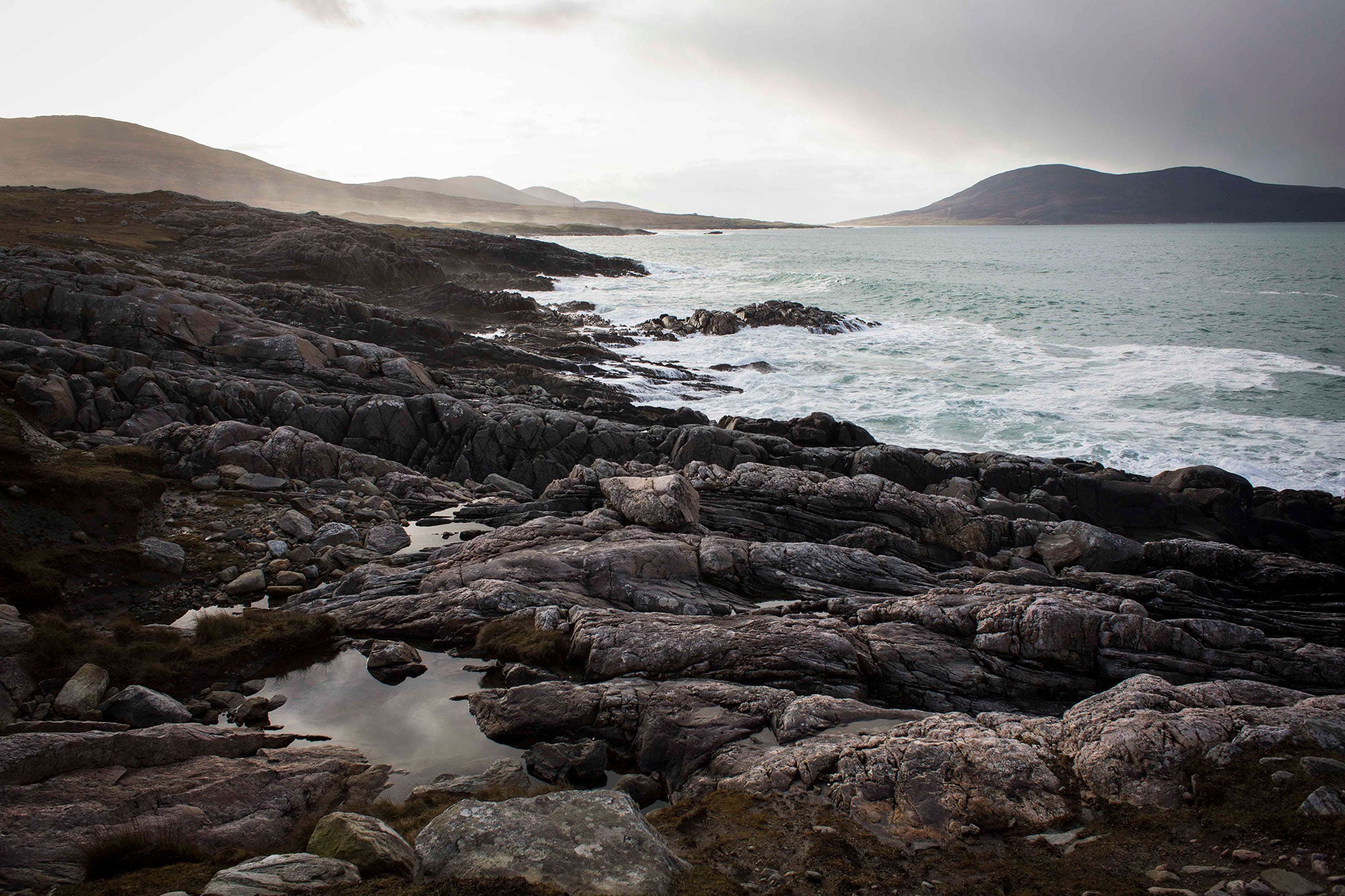 Landscape view of sea and sky in the Hebrides – A breathtaking image capturing the serene beauty of the Hebrides, featuring a vast, calm sea beneath a soft, expansive sky, with natural hues of blue and gray that evoke a peaceful and timeless coastal atmosphere.